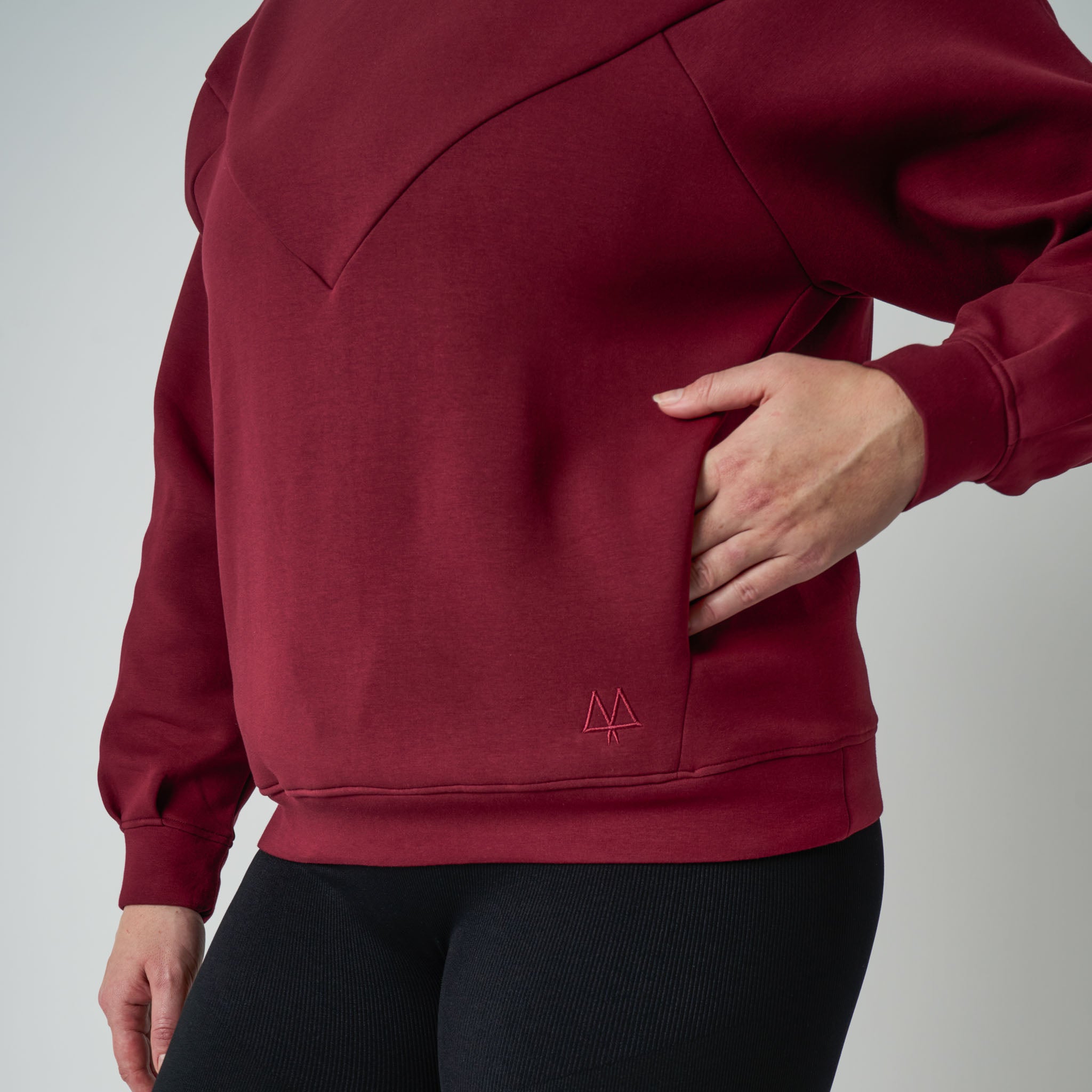 Red hoodie with a logo on a gray background