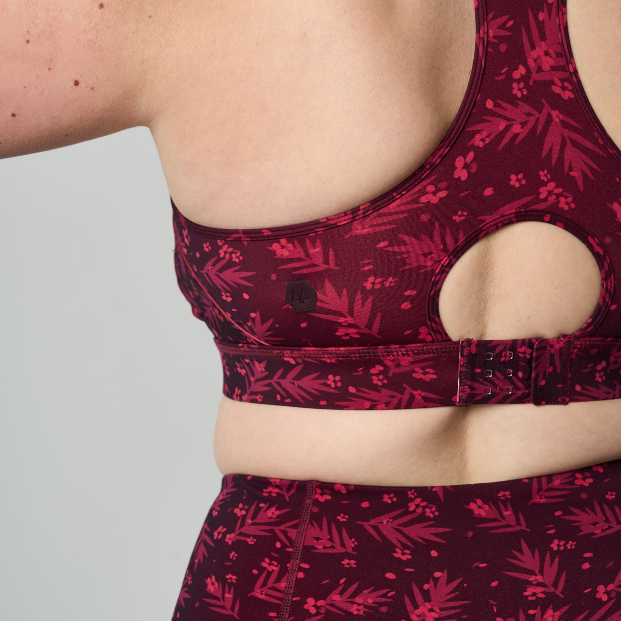 Red floral sports bra on a neutral background