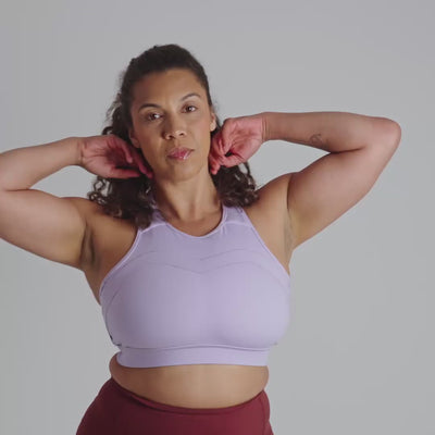 Person wearing a light purple sports bra against a neutral background